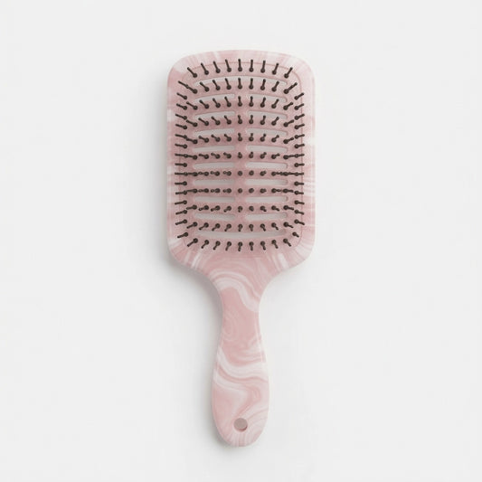Custom marble hair brush designed for retail and salon collections.
